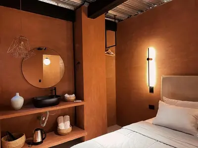 a bedroom with a bed with a mirror and a sink at PROVENZA LUXURY APARTMENTS TERRAZA in Medellín