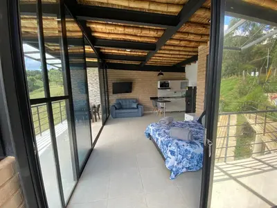 a view of a living room with sliding glass doors at Springfield Ecoloft- Guatapé in Guatapé