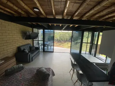 a living room with a bed and a table and chairs at Springfield Ecoloft- Guatapé in Guatapé