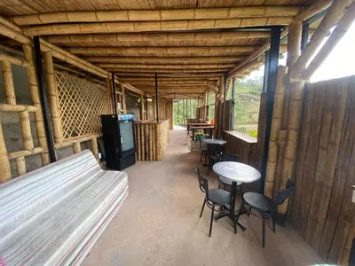an inside view of a cabin with tables and chairs at Springfield Ecoloft- Guatapé in Guatapé