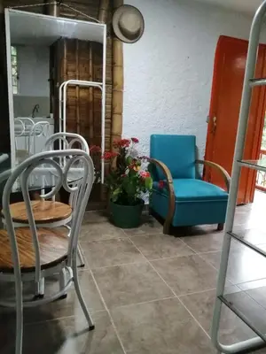 a room with chairs and a table and a chair at Cabaña rural con piscina in Manizales