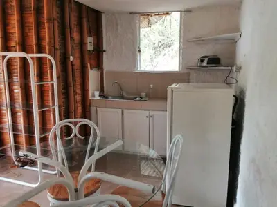 a small kitchen with a sink and a refrigerator at Cabaña rural con piscina in Manizales