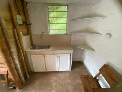 a small kitchen with a sink and a window at Cabaña rural con piscina in Manizales
