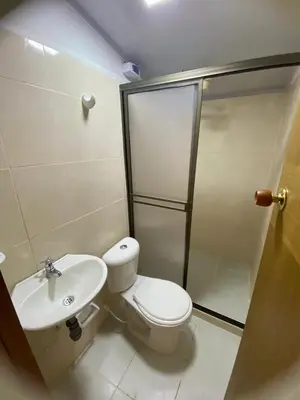 a bathroom with a toilet and a shower and a sink at Cabaña rural con piscina in Manizales