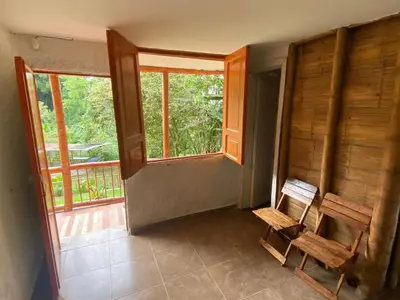 an empty room with a bench and a window at Cabaña rural con piscina in Manizales