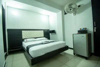 a bedroom with a bed and a fan at Hotel Panorama Medellín in Medellín