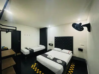 a hotel room with two beds and a bathroom at Hotel Panorama Medellín in Medellín