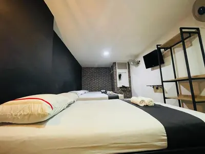 a bedroom with a large white bed and a ladder at Hotel Panorama Medellín in Medellín