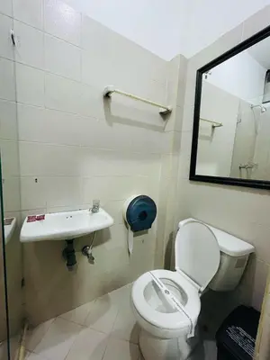 a bathroom with a toilet and a sink at Hotel Panorama Medellín in Medellín