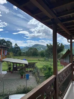 a porch with a view of a picnic table and mountains at Apartamento Campestre 201 in Jardin