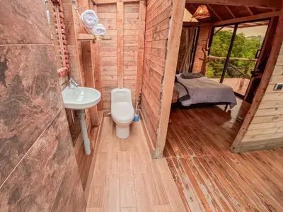 a bathroom with a toilet and a sink in a cabin at Rùstico Glamping in Santa Elena