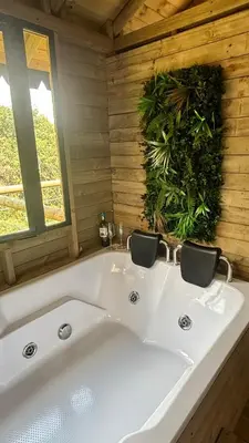 a white bath tub in a wooden bathroom at Rùstico Glamping in Santa Elena
