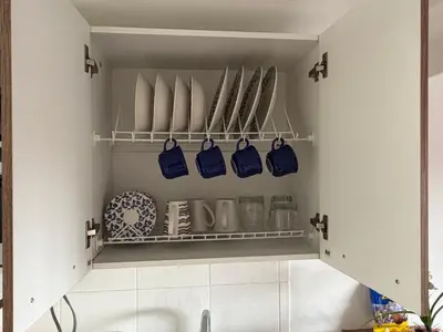 a kitchen with a sink and a shelf with dishes at Amazing one bedroom apartment near the Airport ! in Rionegro