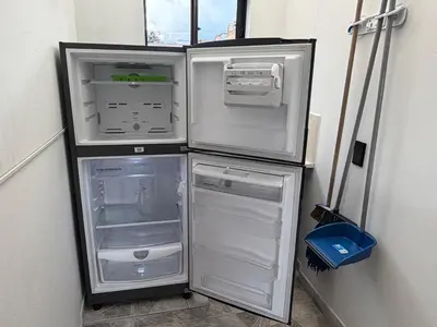 an empty refrigerator with its doors open in a room at Amazing one bedroom apartment near the Airport ! in Rionegro