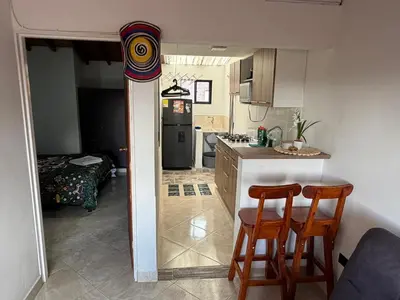 a kitchen with two chairs and a table in a room at Amazing one bedroom apartment near the Airport ! in Rionegro
