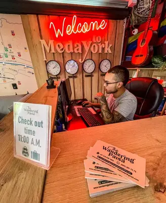 a man sitting at a desk with a welcome to melbourne workshop at The Wandering Paisa in Medellín