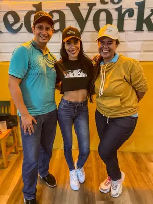 three people posing for a picture in a bowling alley at The Wandering Paisa in Medellín