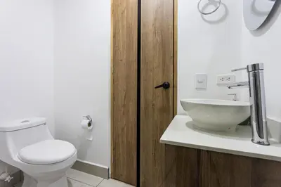 a bathroom with a toilet and a sink at Apartamento Lujoso cerca del Estadio Piso 6to in Medellín