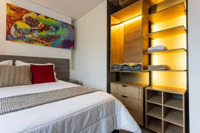 a bedroom with a bed and a closet at Apartamento Lujoso cerca del Estadio Piso 6to in Medellín
