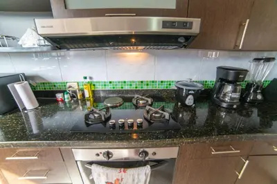 a kitchen counter top with a stove top oven at Top floor apt w/Balcony in El Poblado in Medellín