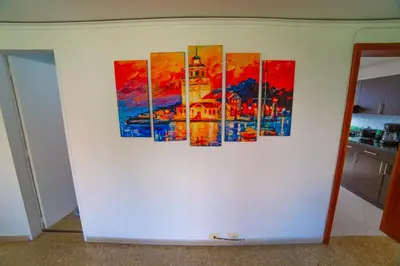 a group of paintings on a wall in a kitchen at Top floor apt w/Balcony in El Poblado in Medellín