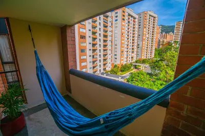 a hammock on a balcony with a view of a city at Top floor apt w/Balcony in El Poblado in Medellín