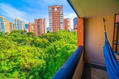 a balcony with a view of a city with tall buildings at Top floor apt w/Balcony in El Poblado in Medellín