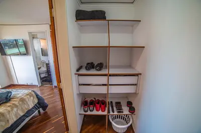 a room with a shelf with pairs of shoes at Top floor apt w/Balcony in El Poblado in Medellín