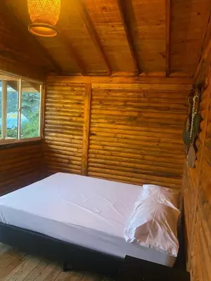 a bed in a room with a wooden wall at El mirador de San Joaquin in San Luis
