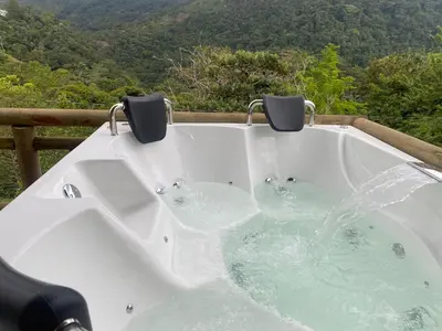 a bath tub with water and two chairs in it at El mirador de San Joaquin in San Luis