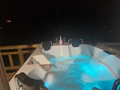 a bath tub sitting on a deck at night at El mirador de San Joaquin in San Luis