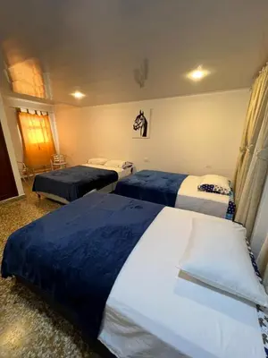 a hotel room with two beds in it at HOTEL GANADERO in La Dorada