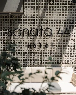 a sign on the side of a building at Sonata 44 Hotel Laureles in Medellín