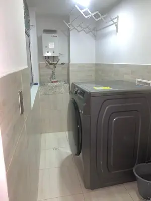 a bathroom with a washing machine in a room at hermoso y nuevo apartamento en laureles in Medellín