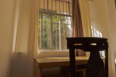 a window in a room with a chair in front of it at hostal casa prado in in Medellín