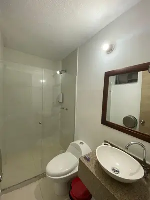 a bathroom with a toilet and a sink and a shower at Hotel Suites 44 Laureles in Medellín