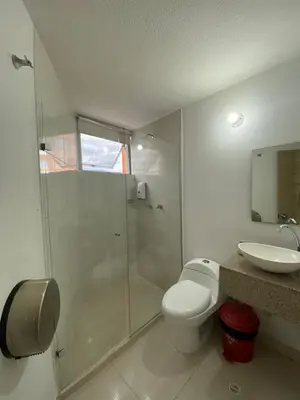 a bathroom with a shower and a toilet and a sink at Hotel Suites 44 Laureles in Medellín
