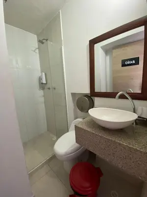 a bathroom with a sink and a toilet and a mirror at Hotel Suites 44 Laureles in Medellín
