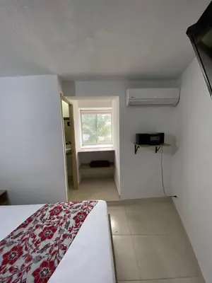 a bedroom with a bed and a window in a room at Hotel Suites 44 Laureles in Medellín