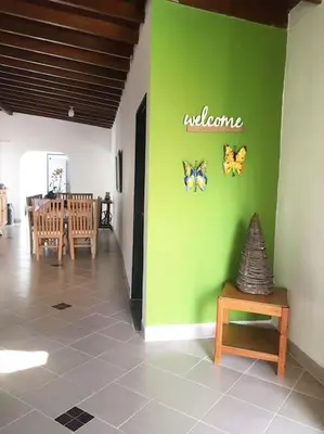 a room with a green wall with butterflies on it at Casa zona Laureles in Medellín