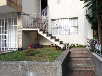 a staircase leading up to a building with flowers at Casa zona Laureles in Medellín