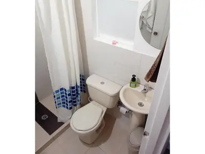 a bathroom with a toilet and a sink and a shower at Casa zona Laureles in Medellín