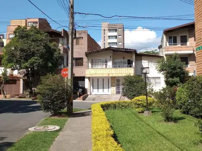 a stop sign in front of a building on a street at Casa zona Laureles in Medellín