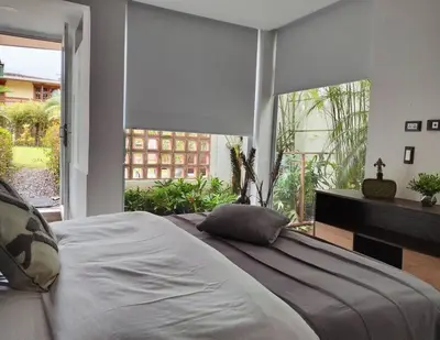 a bedroom with a large bed and a piano at Vivenzza in Jardin