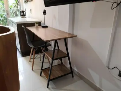 a wooden desk with a chair in a kitchen at Vivenzza in Jardin
