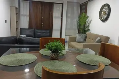 a living room with a glass table and chairs at Vivenzza in Jardin