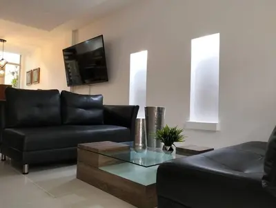 a living room with a couch and a coffee table at Vivenzza in Jardin