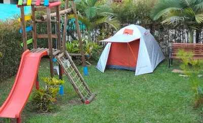 a playground with a tent and a slide at Vivenzza in Jardin