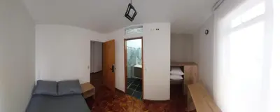 a living room with a couch and a mirror at Casa Palermo Manizales in Manizales
