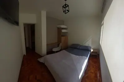 a bedroom with a bed and a desk and a chair at Casa Palermo Manizales in Manizales